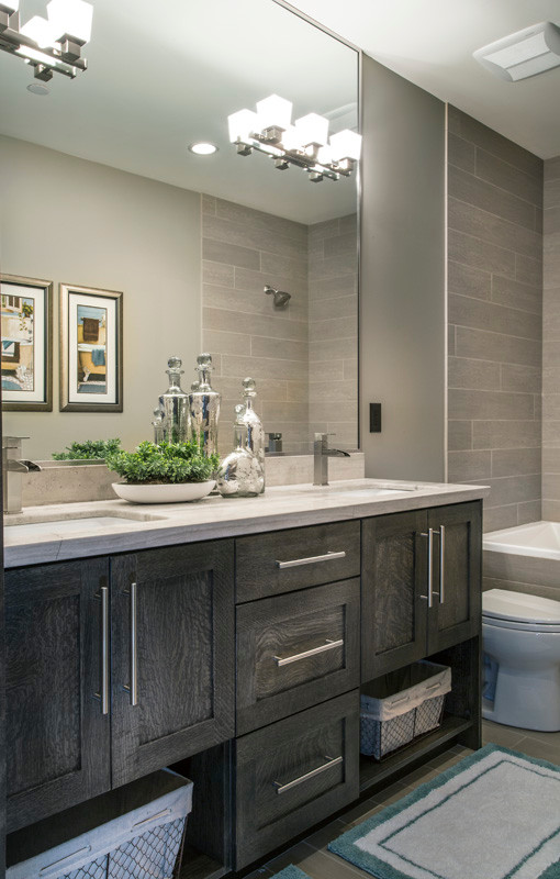 Inspiration for a country bathroom in Salt Lake City with recessed-panel cabinets, grey cabinets, a drop-in tub, a two-piece toilet, gray tile, ceramic tile, grey walls, ceramic floors, a drop-in sink, granite benchtops and a shower/bathtub combo.