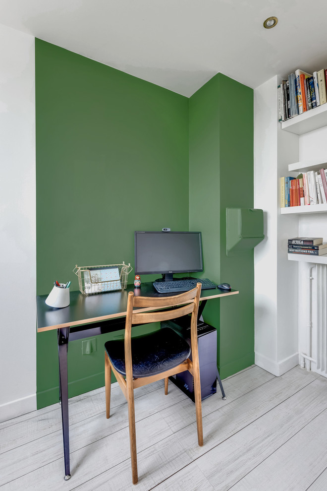 На фото: рабочее место среднего размера в скандинавском стиле с зелеными стенами, полом из линолеума и отдельно стоящим рабочим столом без камина