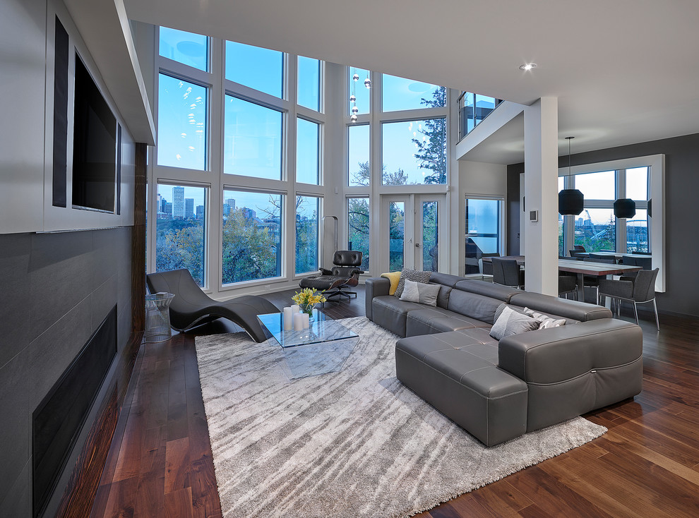 Design ideas for a large contemporary open concept living room in Edmonton with white walls, medium hardwood floors, a ribbon fireplace, a tile fireplace surround and a built-in media wall.