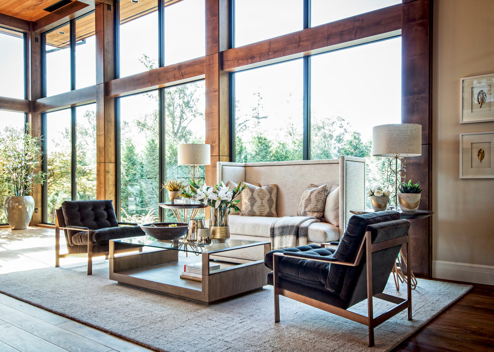 This is an example of a contemporary formal open concept living room in Vancouver with beige walls and dark hardwood floors.
