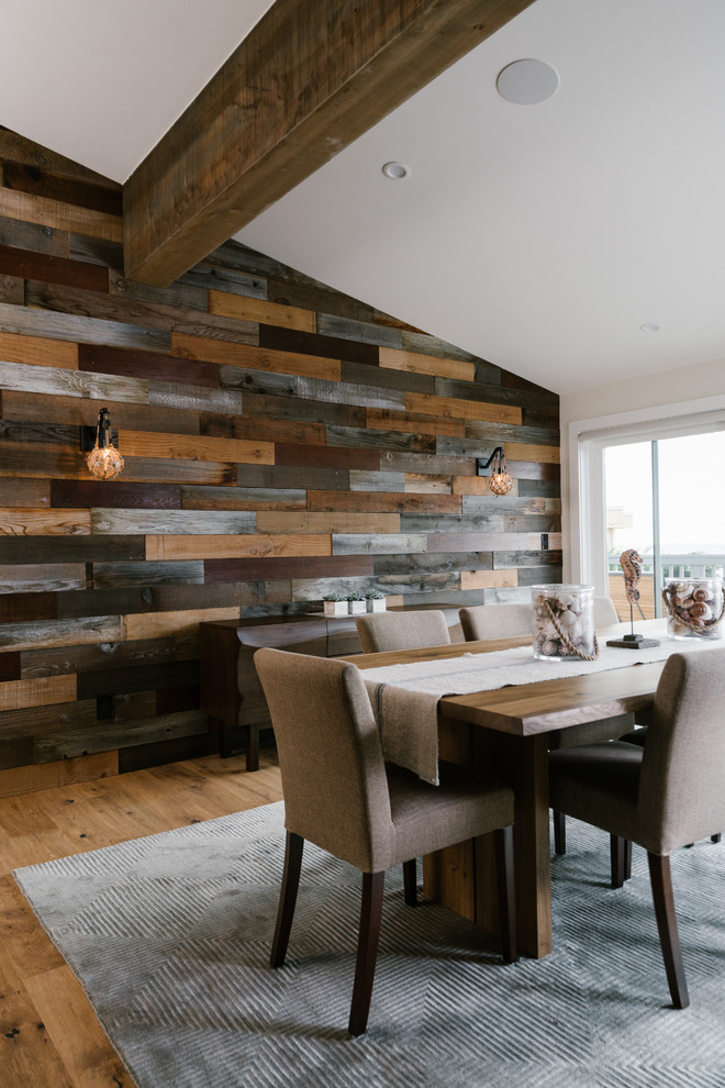 Large beach style open plan dining in San Francisco with dark hardwood floors and multi-coloured walls.