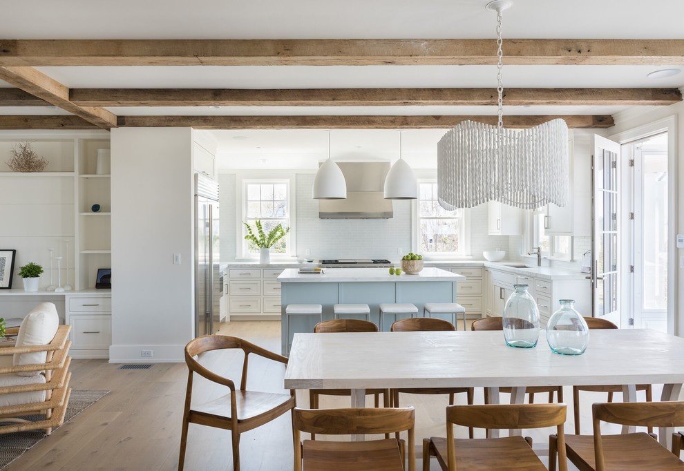 Inspiration for a mid-sized beach style open plan dining in Providence with white walls, light hardwood floors, no fireplace and beige floor.