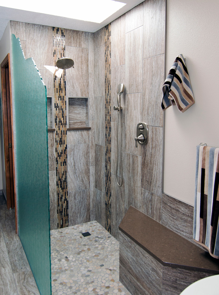 Example of a large mountain style master brown tile and porcelain tile porcelain tile freestanding bathtub design in Seattle with shaker cabinets, dark wood cabinets, a one-piece toilet, beige walls, an undermount sink and quartz countertops
