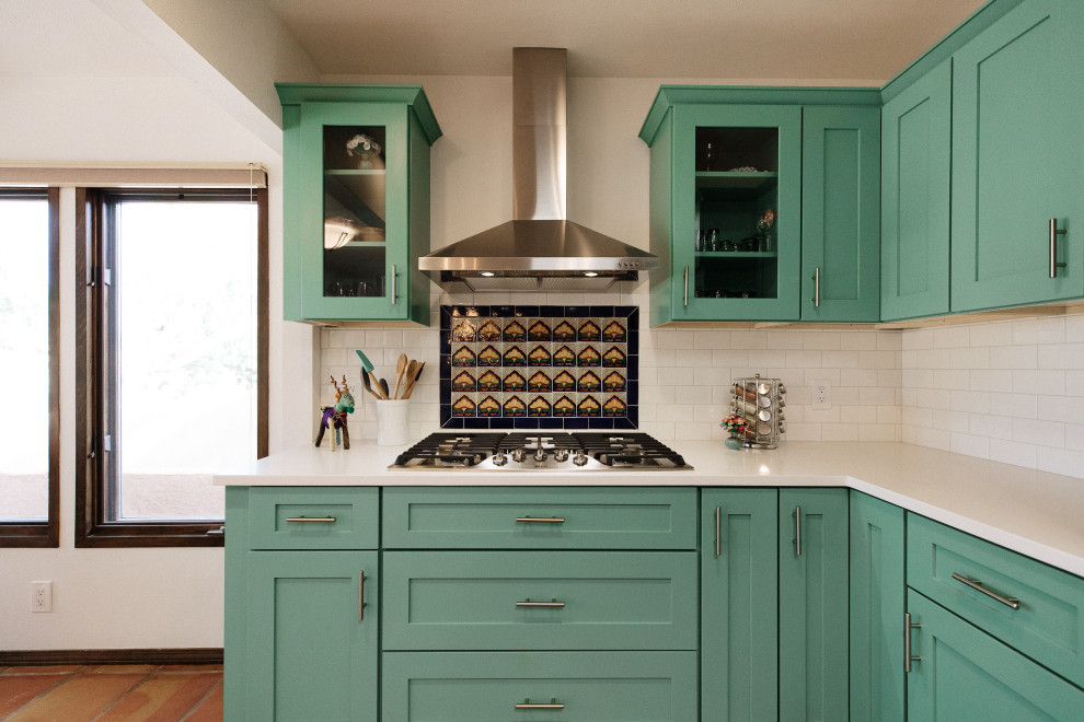 Photo of a mid-sized u-shaped eat-in kitchen in Albuquerque with a single-bowl sink, green cabinets, wood benchtops, multi-coloured splashback, subway tile splashback, stainless steel appliances, terra-cotta floors, with island, orange floor and multi-coloured benchtop.