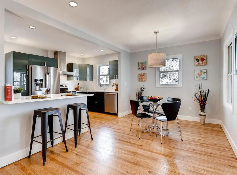 Enclosed dining room - small traditional light wood floor enclosed dining room idea with gray walls