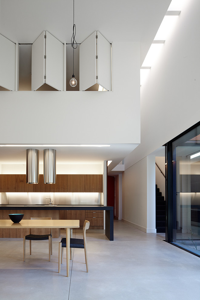 Design ideas for an expansive contemporary kitchen/dining combo in Melbourne with concrete floors.