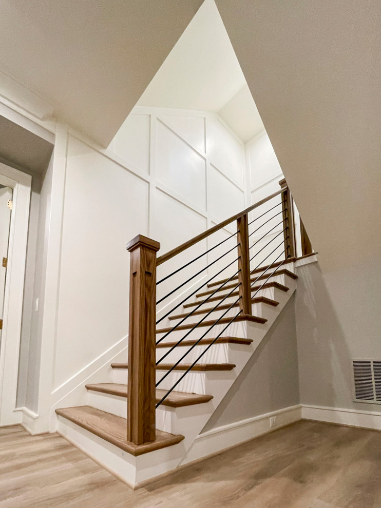 This is an example of a large midcentury wood floating staircase in DC Metro with wood risers and mixed railing.