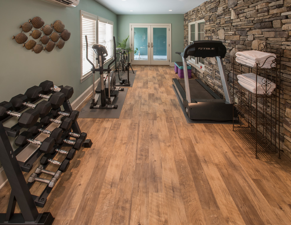 This is an example of a country multipurpose gym in Philadelphia with green walls, vinyl floors and brown floor.