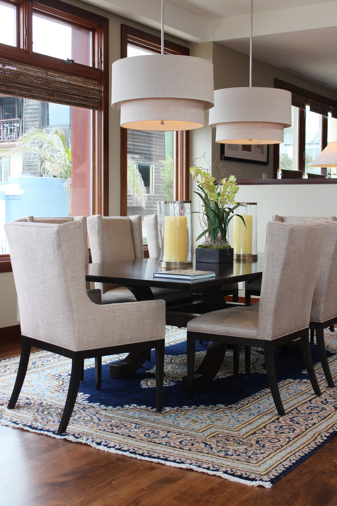 Transitional dining room in Los Angeles with grey walls and dark hardwood floors.