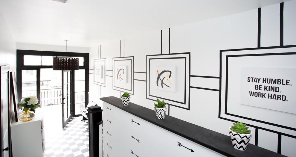 Foyer - mid-sized transitional vinyl floor and white floor foyer idea with white walls and a black front door