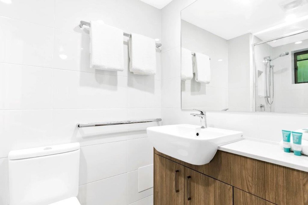 Design ideas for a mid-sized contemporary bathroom in Sunshine Coast with white walls, porcelain floors and grey floor.