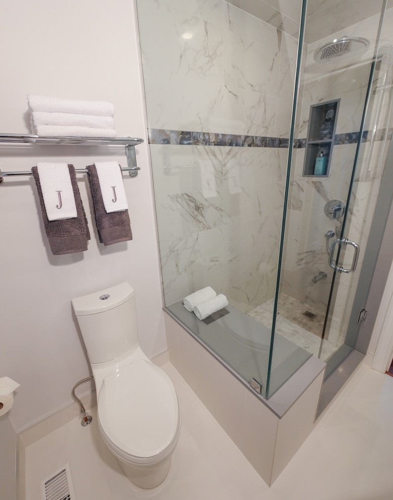 Photo of a mid-sized contemporary 3/4 bathroom in Toronto with flat-panel cabinets, white cabinets, a corner shower, a one-piece toilet, gray tile, white tile, marble, white walls, porcelain floors, an undermount sink, engineered quartz benchtops, white floor and a hinged shower door.