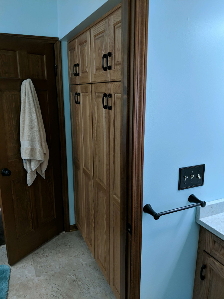 Design ideas for a large traditional master bathroom in Detroit with raised-panel cabinets, medium wood cabinets, an alcove shower, a two-piece toilet, green walls, vinyl floors, an undermount sink, engineered quartz benchtops, multi-coloured floor, a shower curtain and beige benchtops.