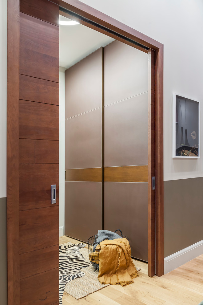 Small contemporary mudroom in Other with grey walls, medium hardwood floors, a sliding front door, a medium wood front door and yellow floor.