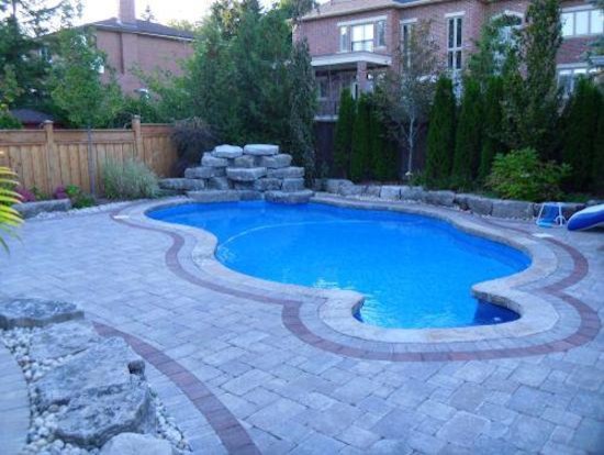 Pool - large backyard custom-shaped pool idea