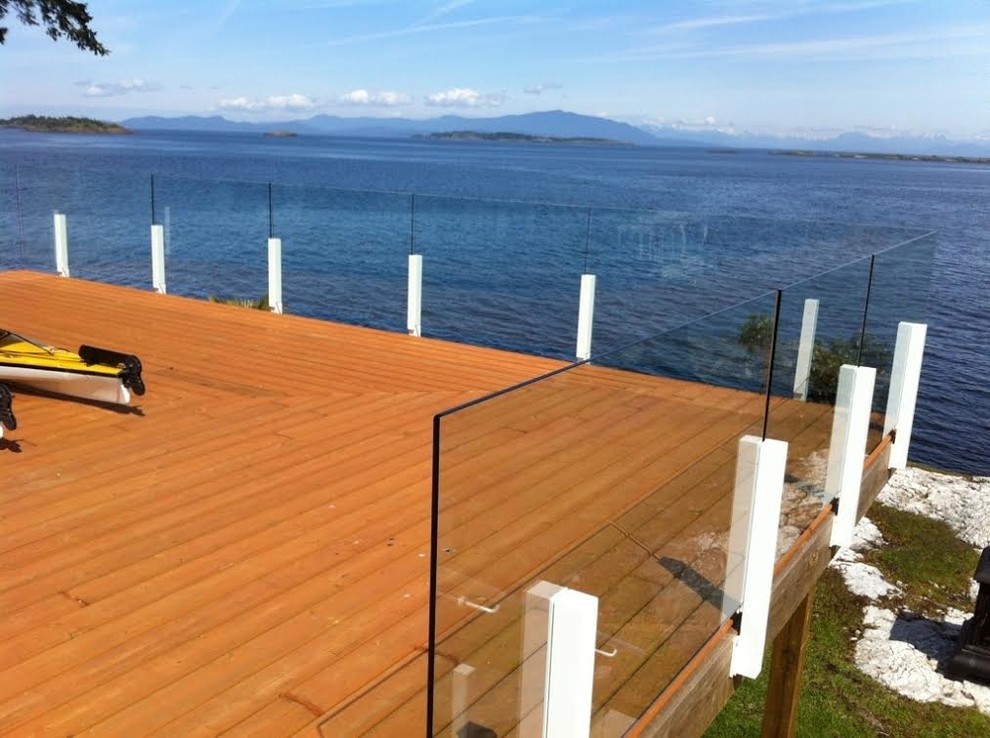 Example of a large transitional backyard deck design with no cover
