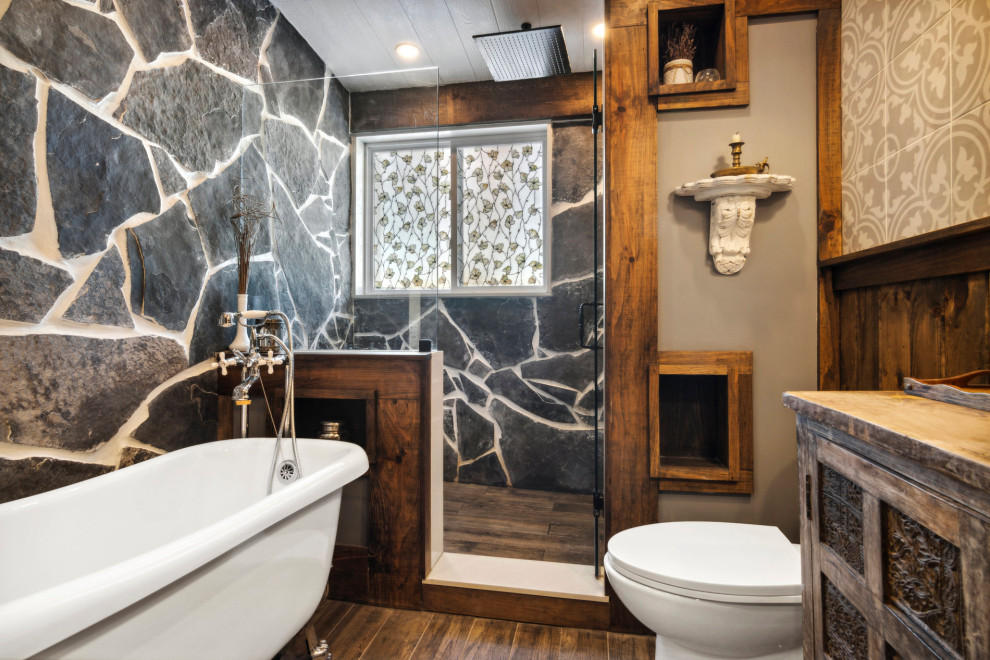 Inspiration for a mid-sized country master bathroom in Other with shaker cabinets, medium wood cabinets, a claw-foot tub, an alcove shower, ceramic floors, wood benchtops, brown floor, a hinged shower door, brown benchtops, a laundry, a single vanity, a freestanding vanity, exposed beam and decorative wall panelling.