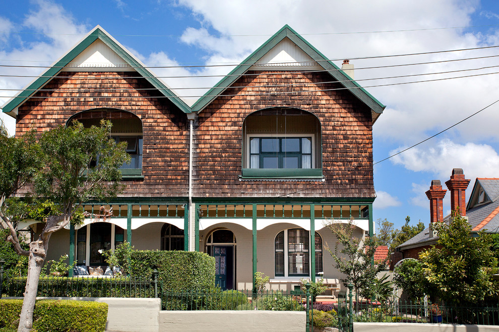 Traditional two-storey brown house exterior in Sydney with mixed siding and a gable roof.