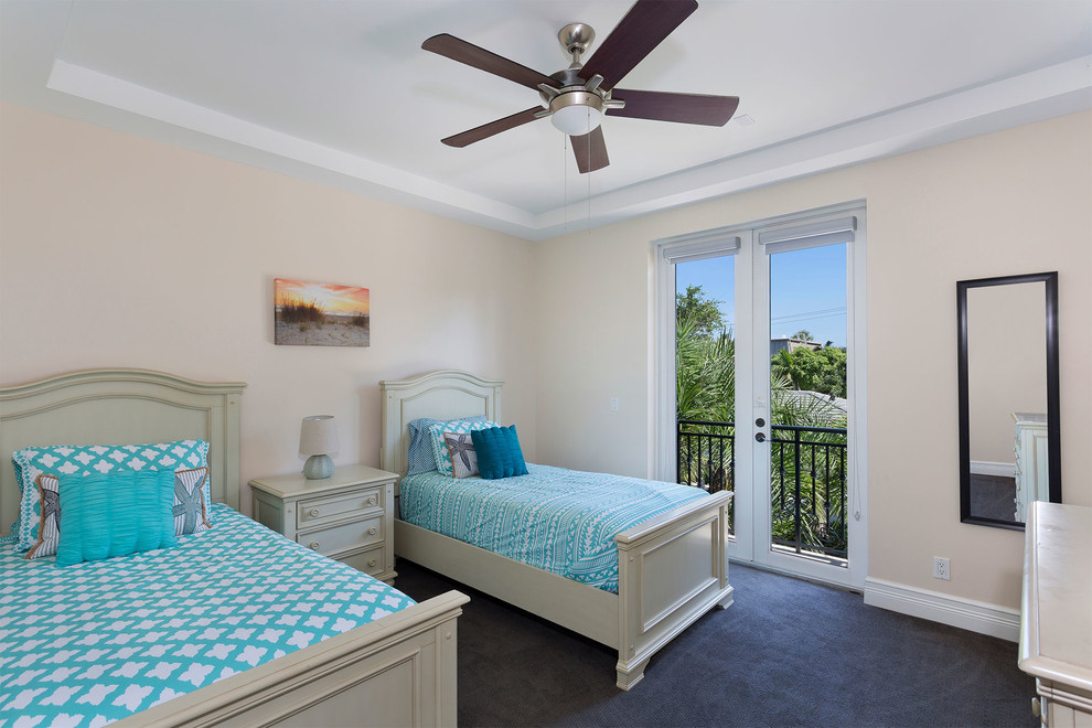 Photo of a mid-sized mediterranean guest bedroom in Miami with beige walls, carpet, no fireplace and blue floor.