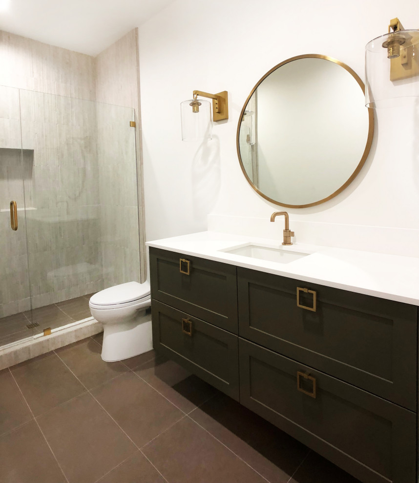 Photo of a mid-sized contemporary 3/4 bathroom in Santa Barbara with shaker cabinets, green cabinets, an alcove shower, a one-piece toilet, brown tile, white walls, porcelain floors, an undermount sink, engineered quartz benchtops, beige floor, a hinged shower door, white benchtops, a single vanity and a built-in vanity.