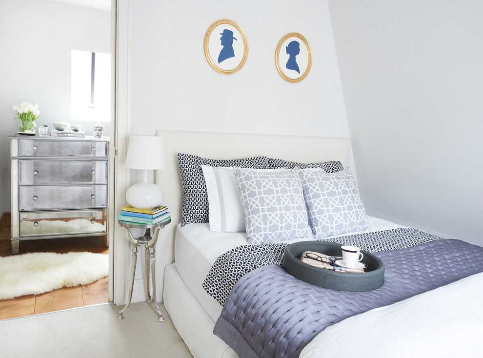 Transitional bedroom in London with white walls.