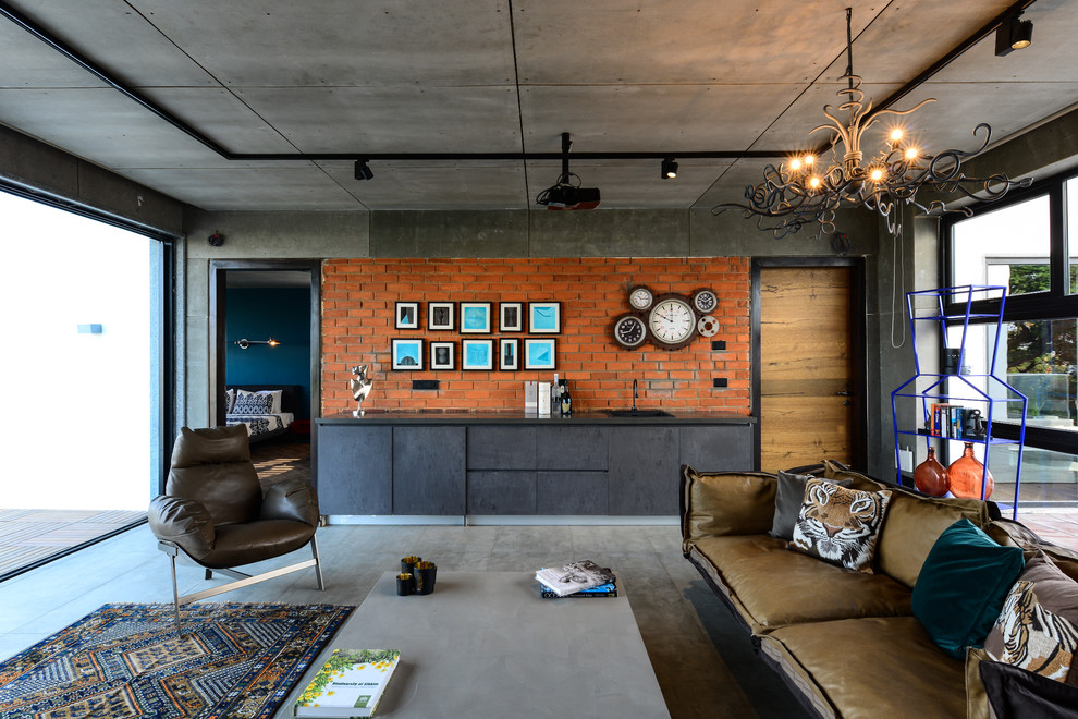 Photo of a mid-sized industrial living room in Hyderabad with concrete floors.
