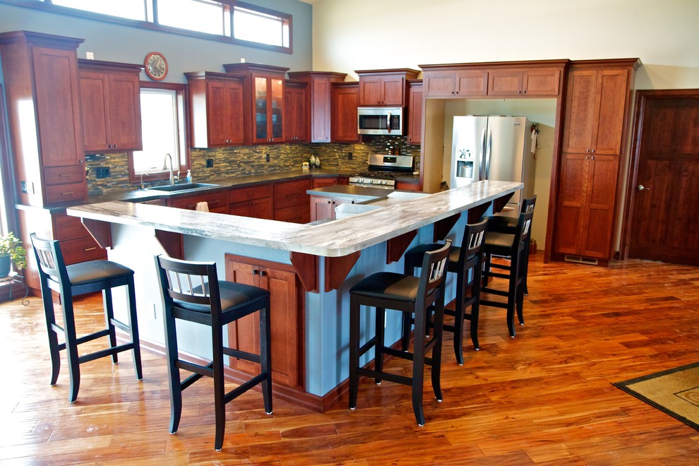Large open concept kitchen photo with raised-panel cabinets, dark wood cabinets, laminate countertops and an island