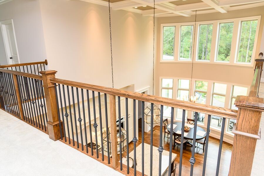 Large transitional wood straight staircase in Raleigh.