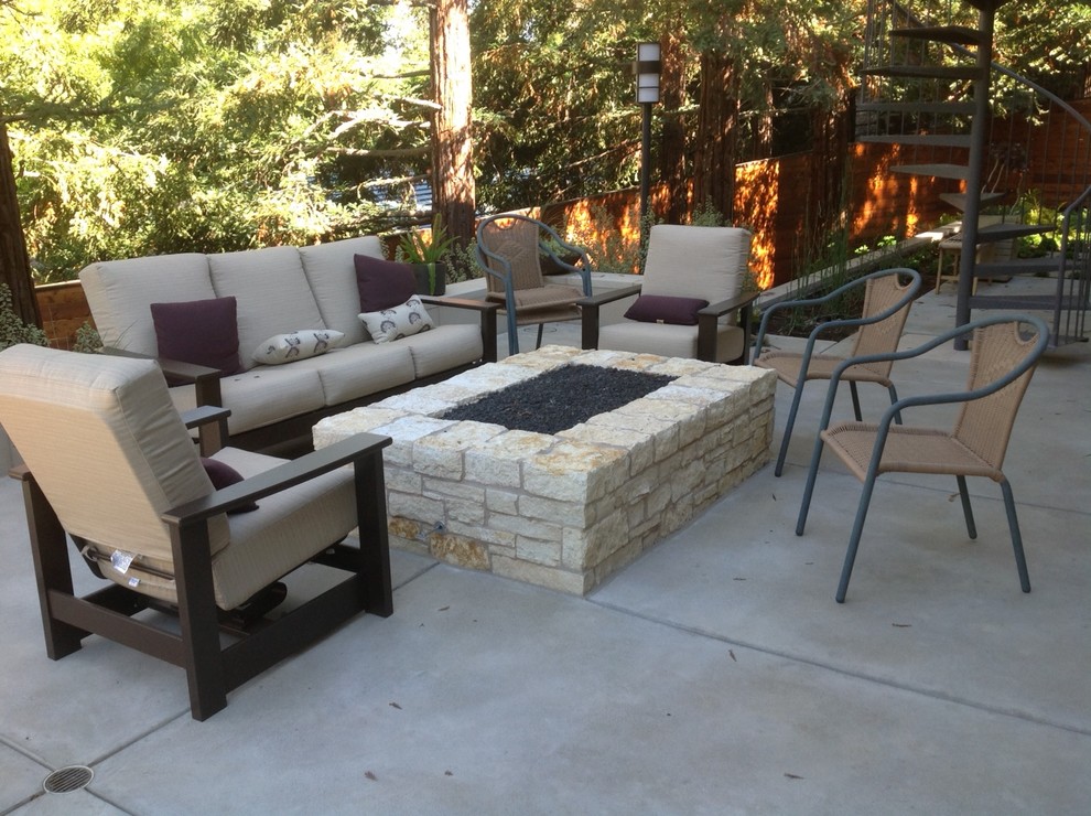 Design ideas for a mid-sized country backyard patio in Other with a fire feature, concrete pavers and a roof extension.