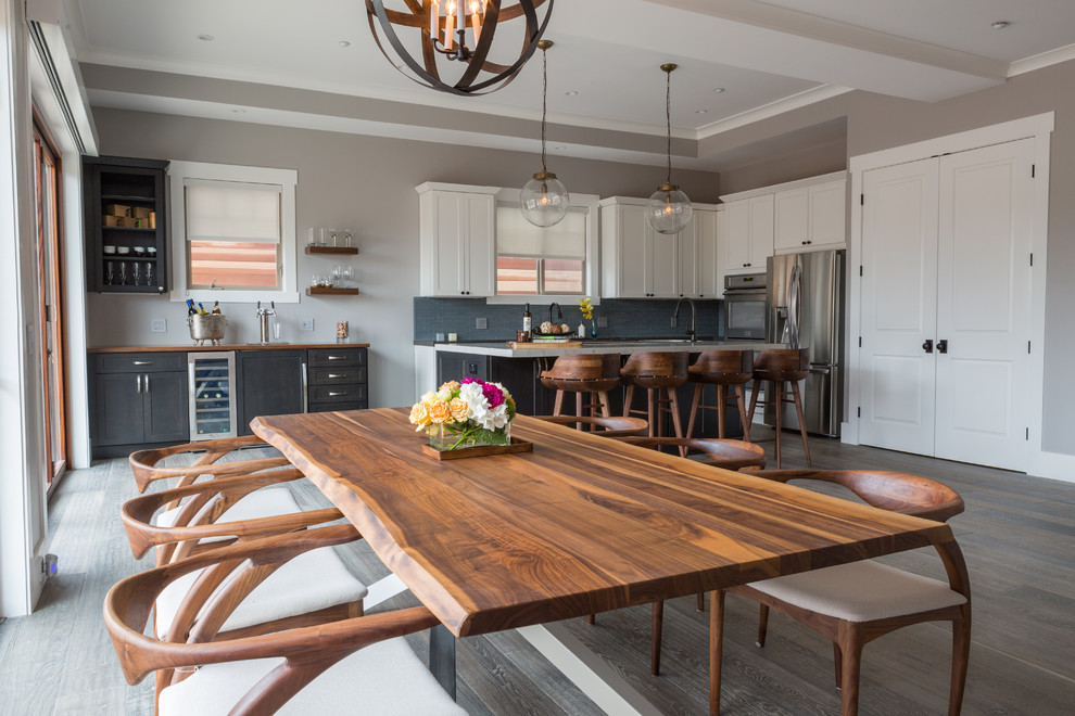 Photo of a mid-sized transitional open plan dining in Los Angeles with dark hardwood floors and grey walls.
