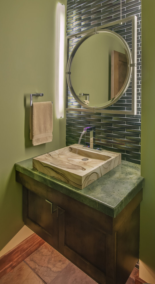 This is an example of a country powder room in Milwaukee with green benchtops.