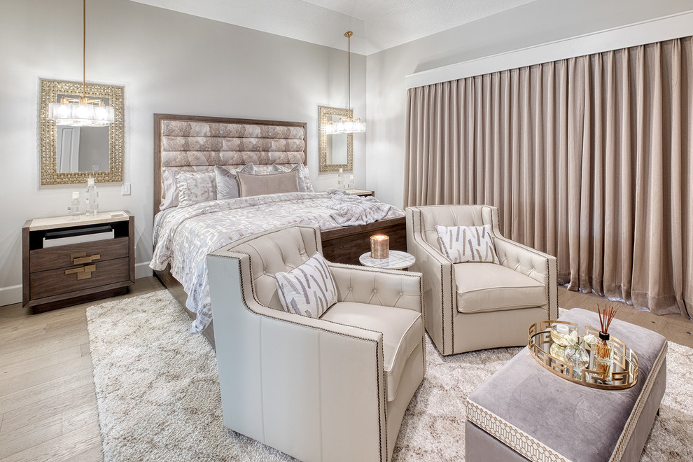 Inspiration for a mediterranean bedroom in Miami with beige walls, light hardwood floors and beige floor.