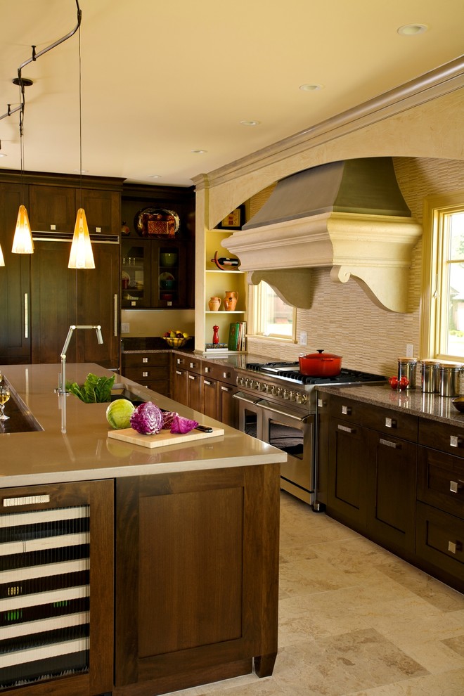 Transitional l-shaped travertine floor eat-in kitchen photo in Boston with furniture-like cabinets, dark wood cabinets, concrete countertops, beige backsplash, stone tile backsplash, paneled appliances, gray walls and an island