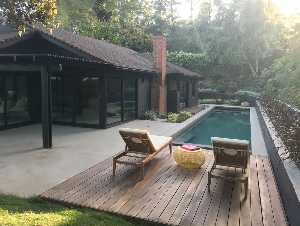 Photo of a mid-sized midcentury backyard patio in Los Angeles with decking and no cover.