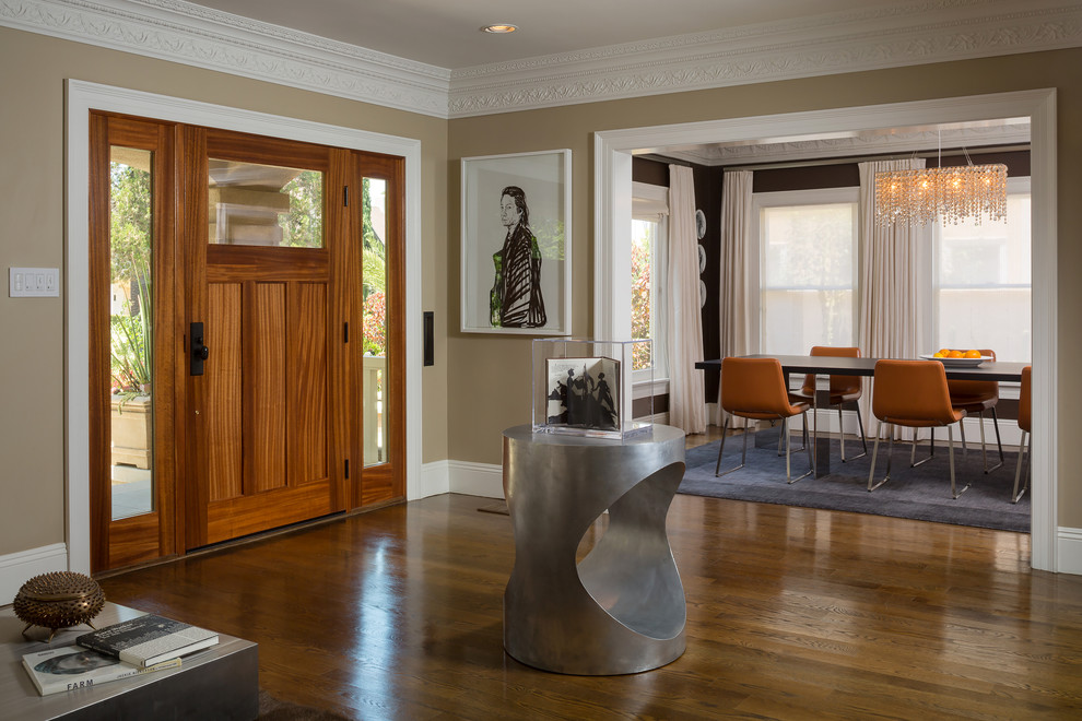 Photo of a contemporary foyer in Los Angeles with brown walls and medium hardwood floors.