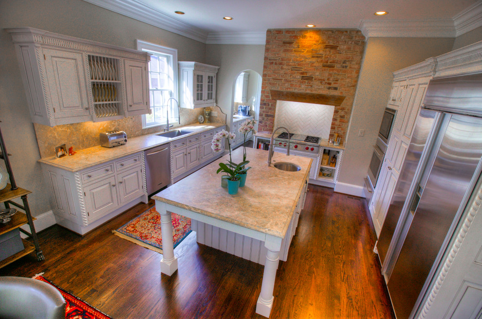 Mid-sized transitional l-shaped medium tone wood floor eat-in kitchen photo in Charlotte with an undermount sink, raised-panel cabinets, white cabinets, marble countertops, multicolored backsplash, stone slab backsplash, stainless steel appliances and an island
