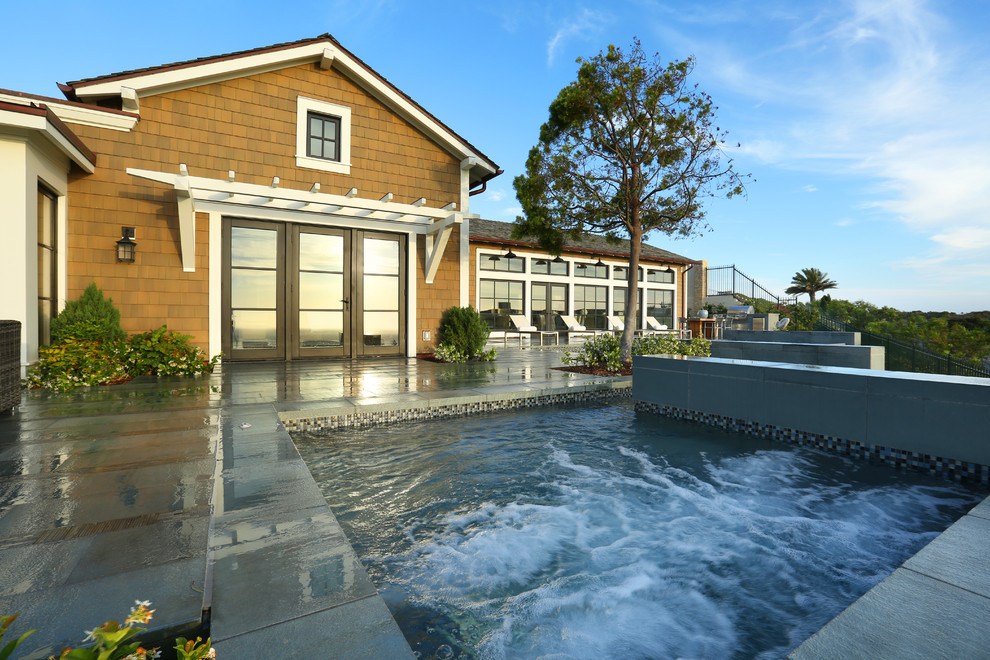 Backyard rectangular pool photo in Orange County