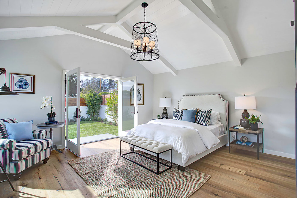 Inspiration for a transitional master bedroom in Los Angeles with grey walls and light hardwood floors.