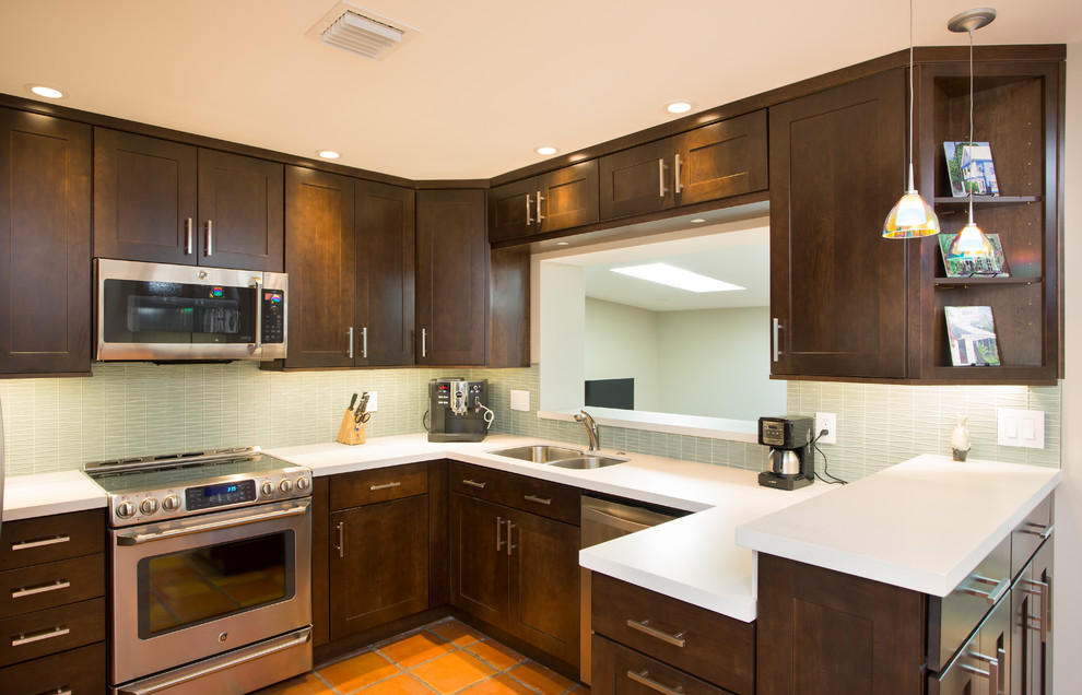 Inspiration for a small transitional u-shaped terra-cotta tile eat-in kitchen remodel in Miami with an undermount sink, shaker cabinets, dark wood cabinets, quartz countertops, green backsplash, glass tile backsplash and stainless steel appliances