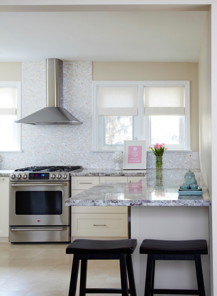 Transitional kitchen in Toronto with metallic splashback and mosaic tile splashback.