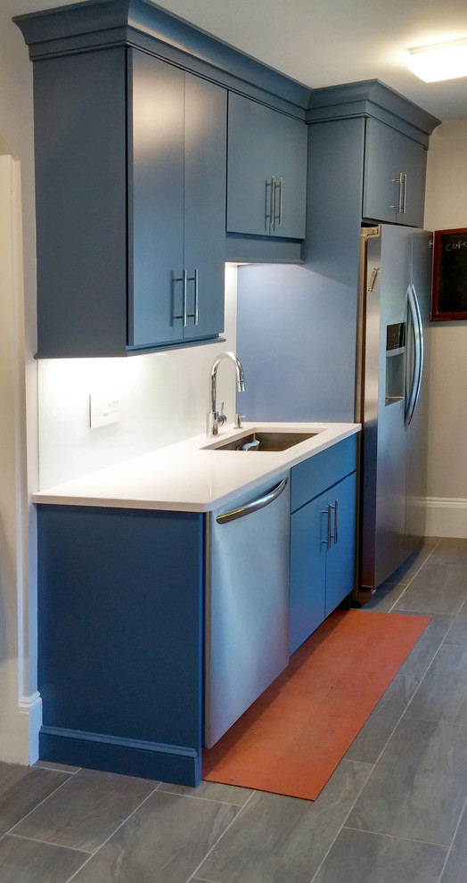 Small transitional galley separate kitchen in Boston with an undermount sink, flat-panel cabinets, blue cabinets, quartz benchtops, white splashback, glass sheet splashback, stainless steel appliances, porcelain floors and no island.