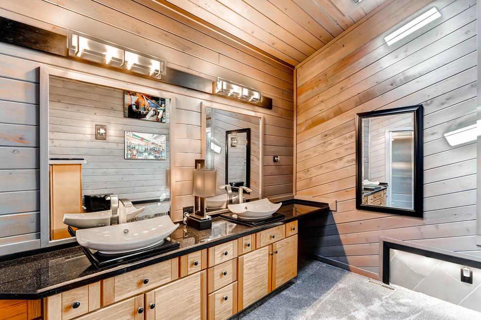 Bathroom - mid-sized rustic master black tile concrete floor bathroom idea in Denver with flat-panel cabinets, light wood cabinets, a one-piece toilet, brown walls, a vessel sink and quartzite countertops