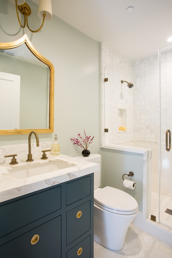 Photo of a transitional 3/4 bathroom in San Francisco with an undermount sink, flat-panel cabinets, an alcove shower, a two-piece toilet, green walls, blue cabinets and white tile.