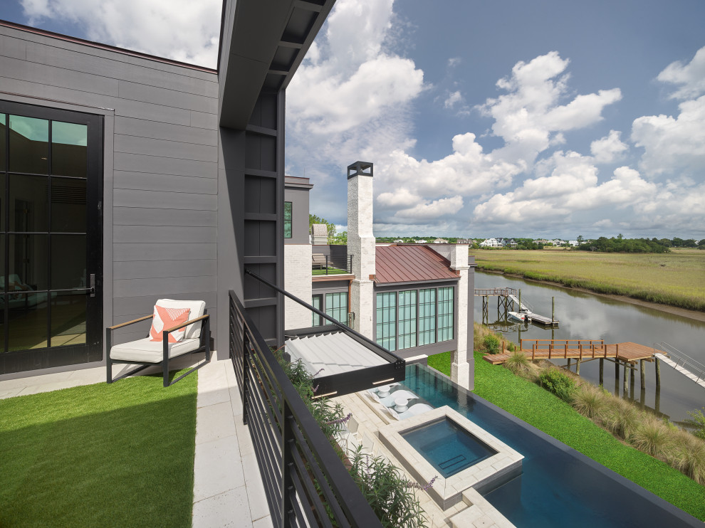 Idee per una grande terrazza minimalista sul tetto e al primo piano con nessuna copertura e parapetto in metallo