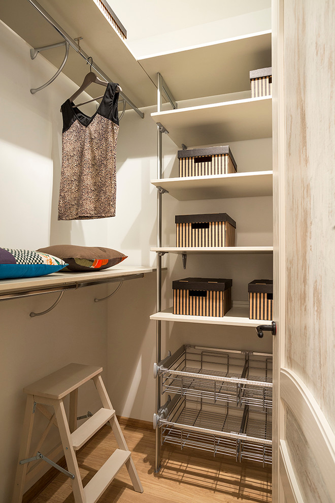 Small contemporary women's walk-in wardrobe in Moscow with open cabinets and beige floor.