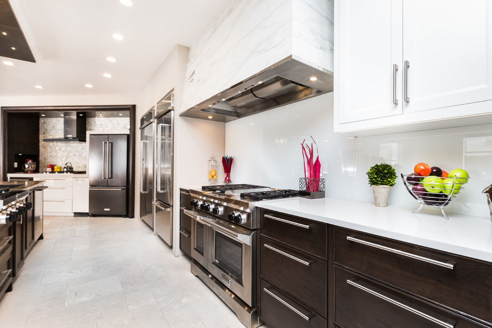 Example of a huge transitional limestone floor kitchen design in Albuquerque with an undermount sink, white backsplash, glass sheet backsplash and an island