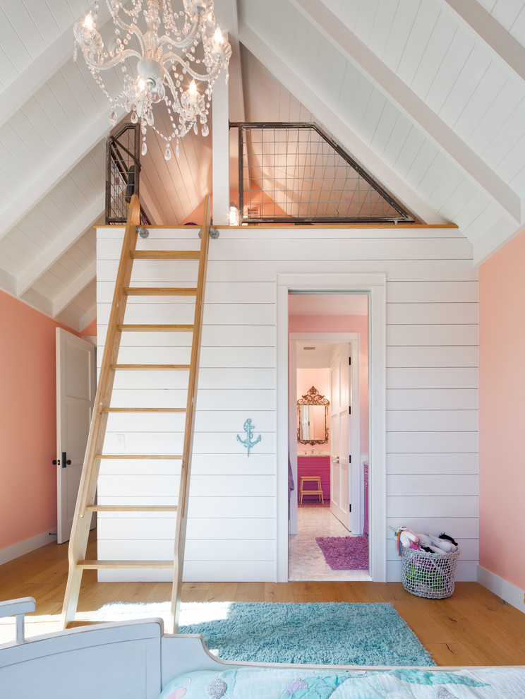 This is an example of a country kids' playroom for girls in Austin with orange walls, medium hardwood floors and brown floor.