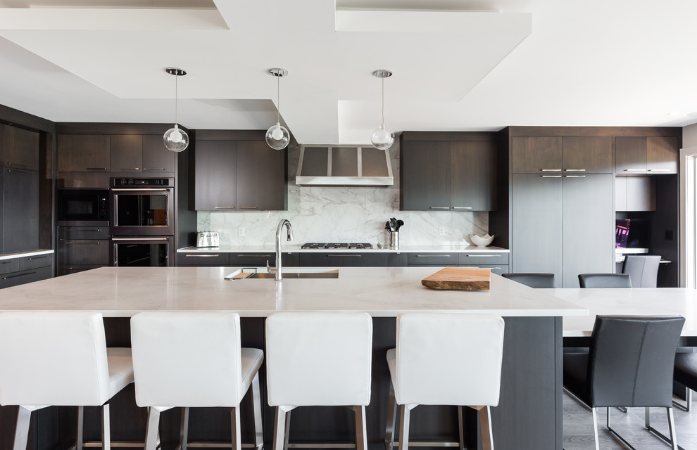 Expansive contemporary l-shaped open plan kitchen in Vancouver with flat-panel cabinets, dark wood cabinets, stainless steel appliances, brown floor, an undermount sink, quartzite benchtops, grey splashback, marble splashback, medium hardwood floors and with island.
