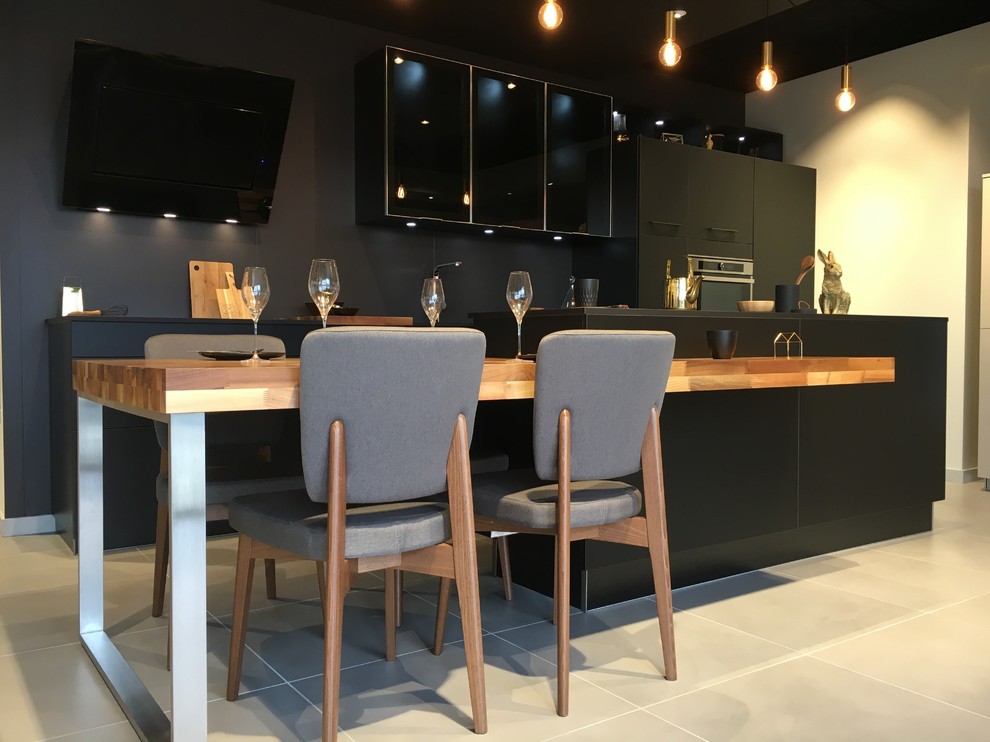 Mid-sized contemporary l-shaped separate kitchen in Grenoble with a single-bowl sink, beaded inset cabinets, stainless steel cabinets, wood benchtops, black splashback, matchstick tile splashback, stainless steel appliances, cement tiles, with island and beige floor.