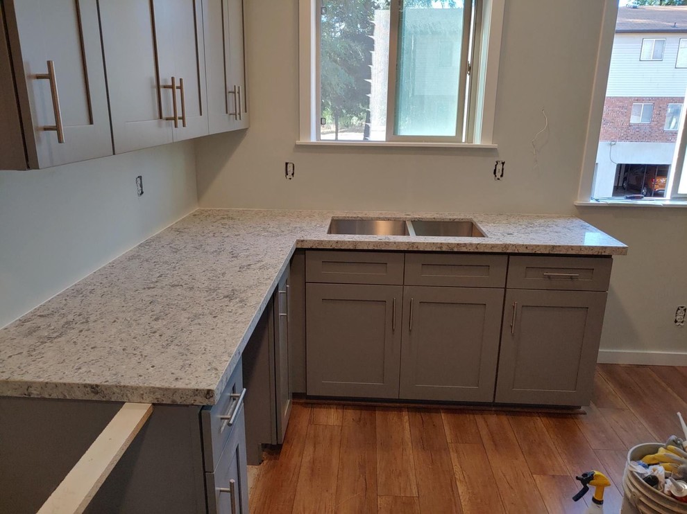 This is an example of a small modern l-shaped eat-in kitchen in Salt Lake City with shaker cabinets, grey cabinets, quartzite benchtops and no island.